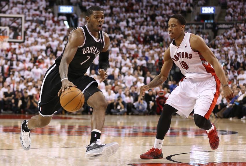 Joe Johnson attacks the basket. Demar Derozan pretends to care.